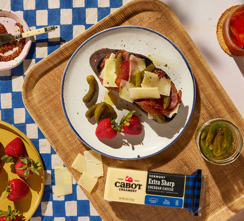 Cabot cheese on a tartine with blue plaid tablecloth