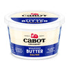 A white and blue tub of Cabot Creamerys Whipped Salted Butter, crafted with pure cream, stands out with its farmer-owned purity. The packaging proudly indicates 36% less fat than regular butter, offering a delightful, spreadable treat.