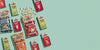Cabot Popcorn and popcorn spilling out of the bag and mac and cheese in boxes on green background