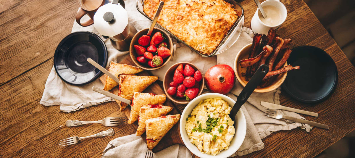 Strawberry Hand Pies, Strawberries, bacon, grits, hashbrown casserole on wooden table