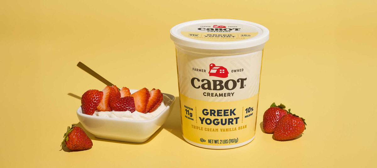 Cabot Vanilla Bean Triple Cream Greek Yogurt with Strawberries on a yellow background