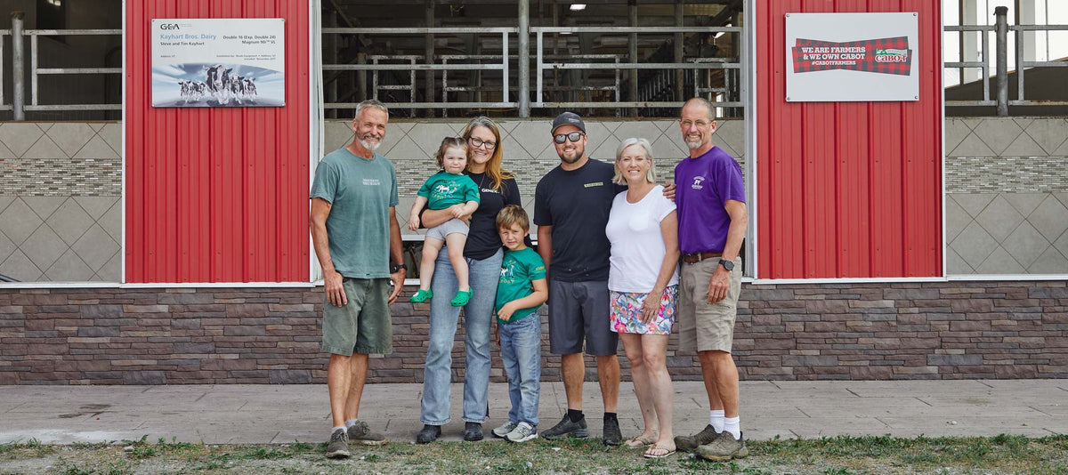 The Kayhart Family standing in front of one of their barns in Vermont