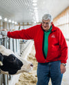 Cabot farmer Bob Foster poses next to one of his cows on his Vermont farm.