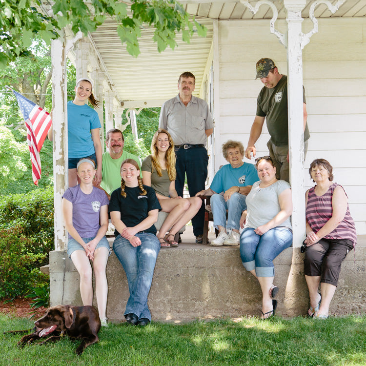 The Cabot farm family, Barstow's are posing together on the farmhouse front porch.