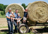 Cabot Farm Family in front of a hay wagon