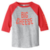 The New Duds Big Cheese Toddler T-Shirt is a gray raglan shirt with red sleeves, made from soft cotton. It features BIG CHEESE in bold red letters on the front and partial CABOT text on the left sleeve, plus an EasyTear label for comfort.