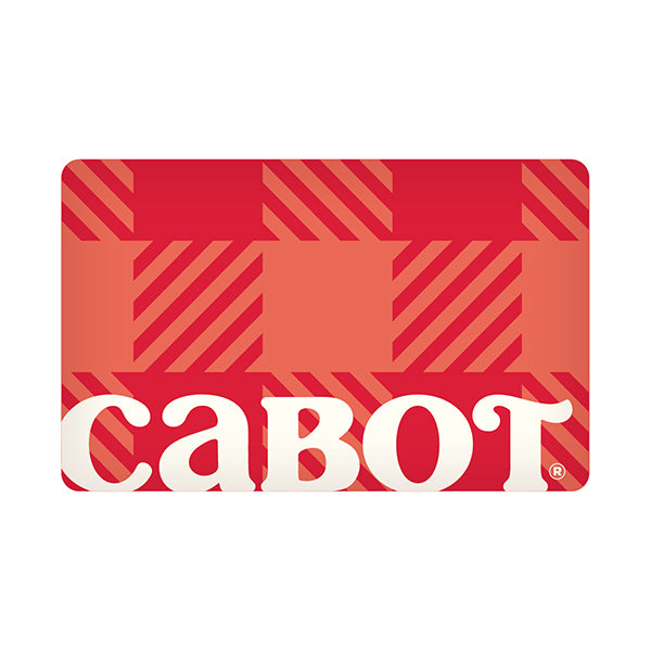 The Cabot Creamery Gift Card is a rectangular card with a red and orange plaid pattern, featuring diagonal stripes and blocks, and the word cabot in large white lowercase letters at the bottom.