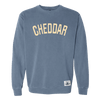 The Cheddar Crewneck by New Duds is a blue sweatshirt featuring the word “CHEDDAR” in large, cream-colored letters across the chest and a small white patch near the hem.