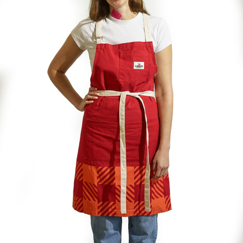 A person wearing the Gallant International Inc. Plaid Apron with beige straps, front pocket, and gear loop over a white t-shirt and blue jeans, standing against a white background.