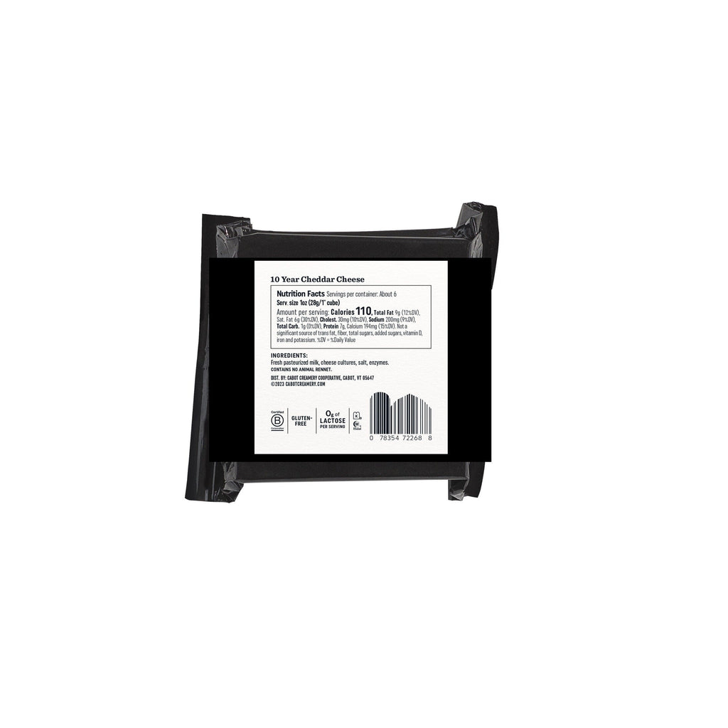 A black package of TEST PRODUCT super-premium 10 Year Cheddar Cheese by Cabot Creamery with a white label featuring nutritional facts, a barcode, and ingredients like cultured milk and enzymes. Its tangy bite and nutty sweetness are sealed in packaging secured with clear tape strips.