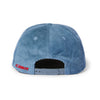 A light blue Butter Corduroy Hat by New Duds, shown from the back, features an adjustable snap closure and “CABOT” embroidered in red on the left side.