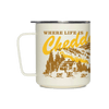 Introducing the “Where Life is Cheddar Insulated Mug” by Miir—a cream-colored camp mug with a handle, adorned with yellow and brown artwork depicting a cabin, cows, trees, and rolling hills. The playful text “WHERE LIFE IS Cheddar,” with “Cheddar” in bold script font, honors the classic charm and heritage of the Cabot cooperative.