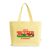 The Life is Butter Tote by New Duds is a yellow bag featuring vibrant red and green text and images. The design includes the phrase “Life is Butter in Vermont” along with illustrations of cows, a barn, and trees beneath the words. With its handy zip-top closure, this tote celebrates classic Vermont charm.