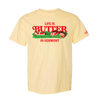 The New Duds Life is Butter in Vermont T-shirt features a yellow base with red “LIFE IS BUTTER IN VERMONT” text and a centered illustration of barns and a field on the chest.
