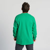 A person with short dark hair is standing facing away from the camera, wearing the New Duds Fresh from Vermont Long Sleeve Chainstitched T-shirt in bright green and dark pants against a plain light background.