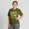 A smiling person wears the New Duds Where Life is Cheddar T-shirt, featuring a colorful graphic and text, while standing against a plain, light background.