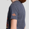 A person wearing a heather blue Seriously Sharp Riddle Youth T-shirt by New Duds, featuring the orange Cabot Creamery logo on the sleeve, shown from the side against a plain light background. This stylish tee is perfect for fans of Seriously Sharp Cheddar.
