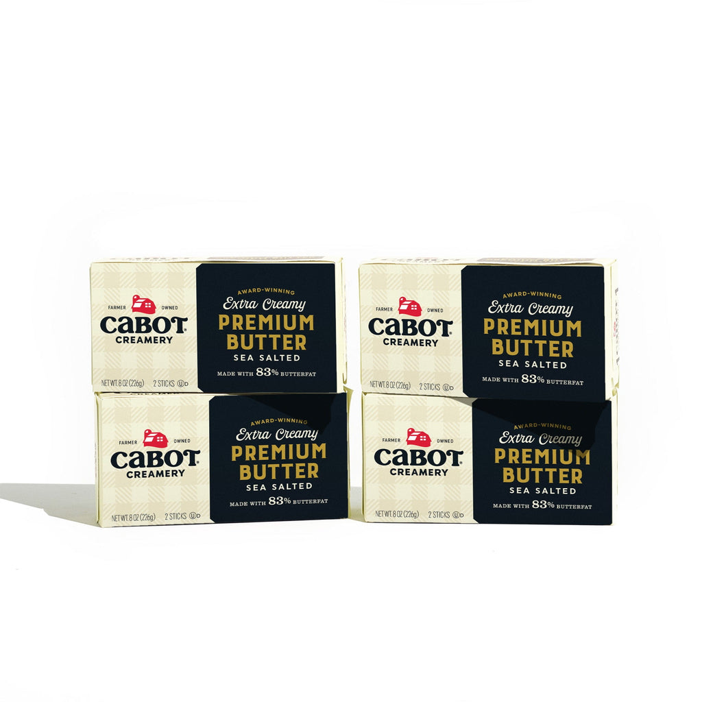 Four boxes of Cabot Creamery’s The World’s Best Butter (4 Pack), crafted for rich flavor and smooth texture, are stacked in two rows against a white background—ideal for butter lovers seeking premium quality.