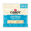 A 2 oz package of Cabot Creamery Plain Cheddar Cheese Curds features a blue and cream label showing protein, calcium, and cooperative certification. The farm-fresh curds are visible, highlighting their signature squeaky texture.