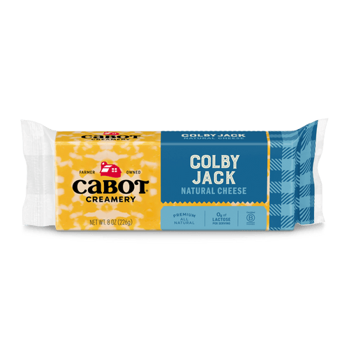 An 8 oz (226g) package of Cabot Creamery Colby Jack Cheese with a yellow and blue label features the Cabot logo, cheese description, and icons for premium quality, natural, lactose-free, and ideal for shredding or melting.