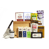 A Cabot X That Cheese Plate: Ultimate Charcuterie Gift Box featuring award-winning cheeses, salami, olives, pecans, crackers, a jar of spread, and a cheese cleaver on a wooden board.