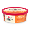 Round container of Garden Vegetable Cream Cheese by Cabot Creamery. It has a red lid, plaid orange label with the Cabot logo, and contains 8 oz (226g) of fresh cream cheese packed with crunchy garden veggies.