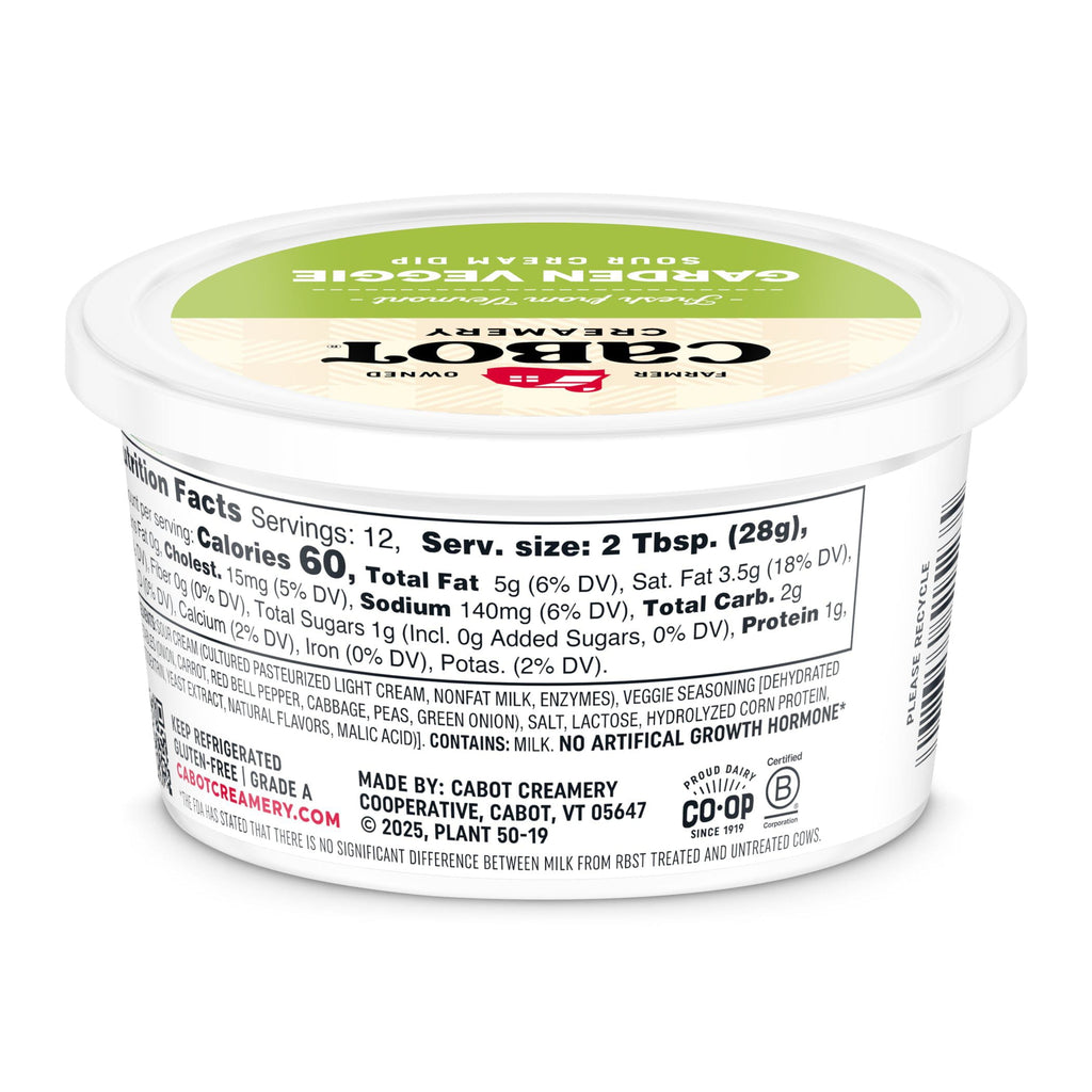 A tub of Cabot Creamery Garden Veggie Dip, ideal as a dip or salad topping, displays nutrition facts, ingredients, and company info on the side of its white container with a green-and-white lid.