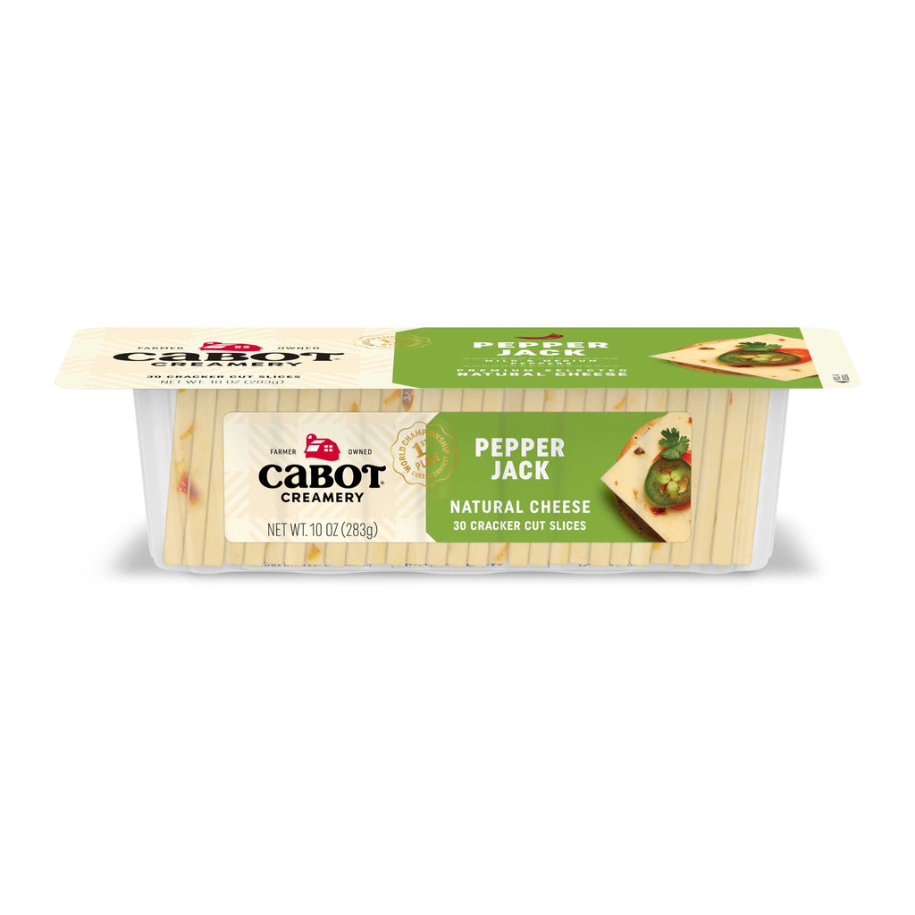 A 10 oz package of Cabot Creamery Pepper Jack Cheese cracker-cut slices, featuring a green label with images of cheese slices topped with herbs and jalapeno peppers.