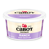 A 12 oz container of Cabot Creamery Ranch Dip with a purple and cream plaid design and the signature red barn logo on the lid and label.
