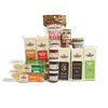 The Cabot Creamery Cheese Pairing Collection features award-winning cheese blocks and sticks, Vermont maple spiced pecans, caramel sauce, hot honey, and red pepper jelly—an irresistible assortment displayed against a white background.