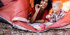 Mother and daughter eating Cabot cheese in a tent