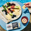 Poolside snack of melon, prosciutto, grapes and berries with Cabot cheese slices.