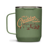 The Pyrographics Life is Cheddar in Vermont Insulated Mug is green with orange lettering and features illustrations of a barn, cows, trees, and mountains.