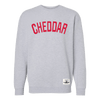 The Northmade Varsity Cheddar Stitched Crewneck is a light gray premium cotton unisex sweatshirt with "CHEDDAR" in bold red letters on the chest and a small white Cabot Creamery label near the hem.