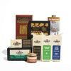 The Cabot Creamery Vermont Maple & Cheese Gift Box features cheddar cheeses, salted crackers, maple syrup, caramel sauce, and leaf-shaped cookies, all beautifully arranged on a white background.