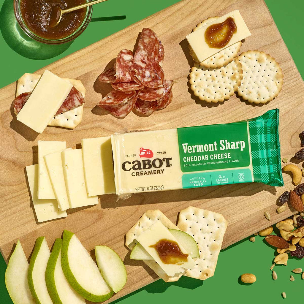 Cabot Vermont Sharp Cheddar Cheese with Crackers, pears, salami, nuts and a spread.