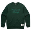 The Vermont Sharp Chainstitched Crewneck by New Duds is a dark green sweatshirt featuring chain-stitched Vermont Sharp lettering and a woven Cabot Creamery patch, made from reclaimed plastic bottles.