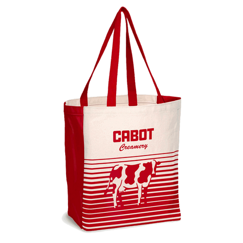 The Cabot Cow Graphic Tote by Enviro-Tote, Inc. features a red and white design with “Cabot Creamery” text and a cow graphic above horizontal stripes. This rectangular tote bag includes two red handles.