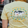 A person wearing the New Duds Cabot x Always With Honor Crop T-shirt featuring a pixel art cow, flowers, and Fresh From Vermont printed on the back.