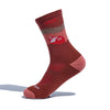 The Darn Tough Vermont Cabot x Darn Tough Socks in Chestnut is a single Merino wool hiking sock, red and brown with geometric rectangles and squares in lighter shades, shown upright on a white background with a faint shadow.