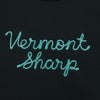 The New Duds Vermont Sharp Chainstitched Crewneck features Vermont Sharp chain-stitched in light blue cursive on a dark fabric background.
