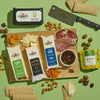 The Cabot Creamery X That Cheese Plate: Ultimate Charcuterie Gift Box features award-winning cheeses, dried apricots, salami slices, crackers, fig spread, and olives on a board with a cheese knife and extra crackers.