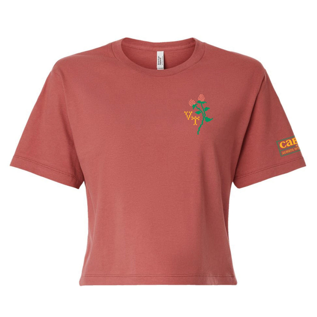 The Cabot x Always With Honor Cropped T-shirt by New Duds is a dusty rose, boxy fit tee in soft ring-spun cotton, featuring a small embroidered flower on the left chest and yellow Cabot text on the left sleeve.