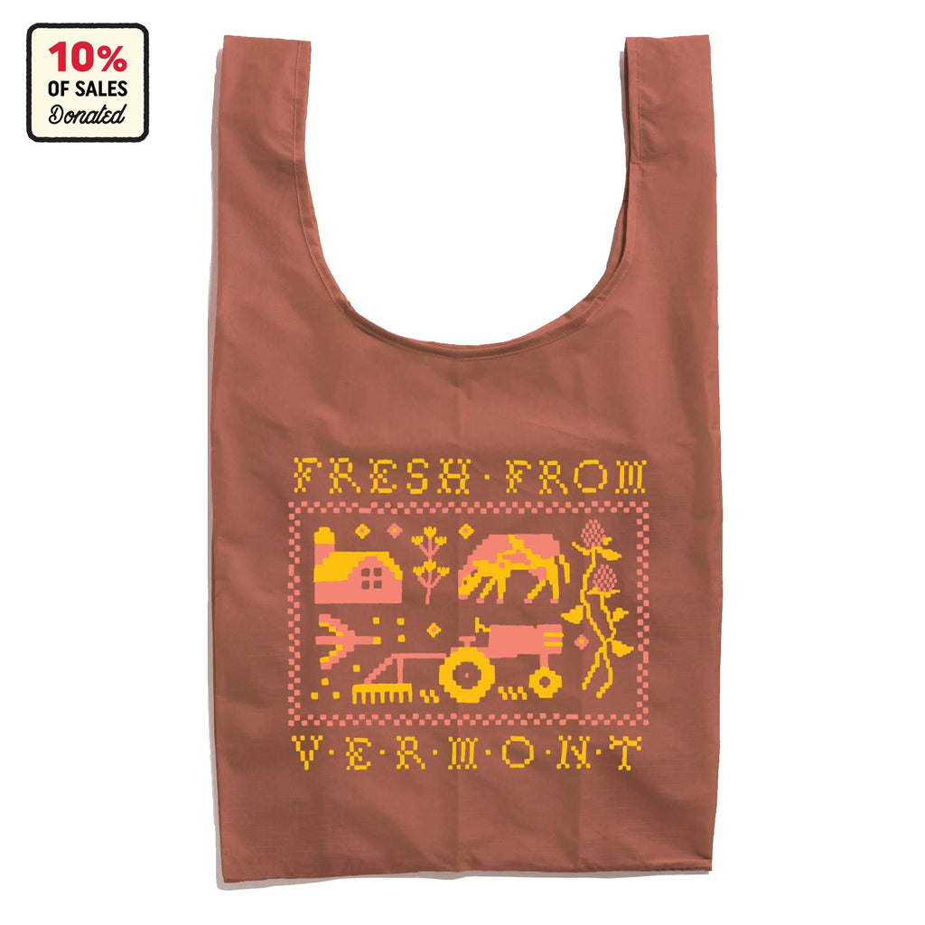 The Cabot x Always With Honor Baggu by Baggu is a reusable tote with a yellow and pink farm scene and “Fresh From Vermont” text. Eco-friendly, it supports a farmer-owned co-op with 10% of sales donated—perfect for shopping sustainably.
