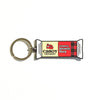 The Seriously Sharp Charm Keychain by WizardPins is shaped like a Cabot Creamery cheese package, featuring a Vermont Seriously Sharp label, red and black plaid design, and silver key ring—a fun accessory for cheese lovers.