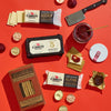 A flat lay of the Salty & Sweet Gift Pack by Cabot Creamery, featuring Vermont cheeses, salted maple Castleton crackers, jam with spreader, chocolate coins, and a mini cleaver—perfect for cheese and chocolate pairing.