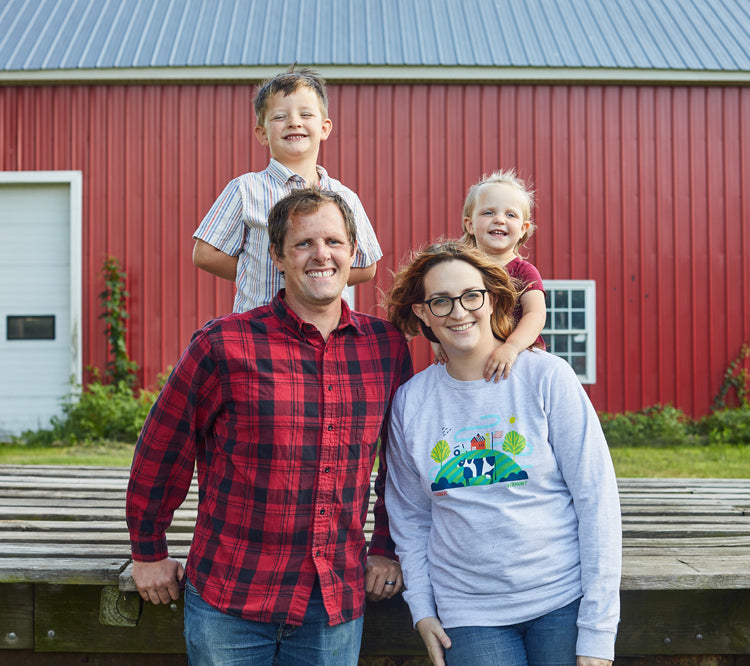 Cabot Farm Family posing in front of a red barn