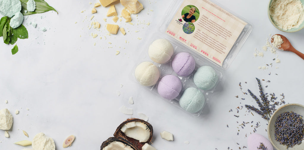 Cabot farmer made bath fizzes on a background with various spa ingredients around it.