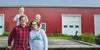 Cabot Farm Family posing in front of a red barn